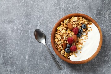 Delicious granola with berries and yogurt on a light background