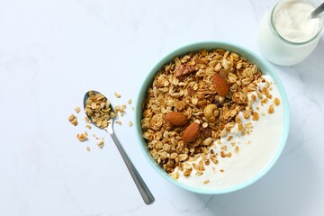 Delicious granola with yogurt on a light background