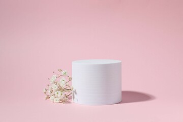 Podium and white gypsophila on color background