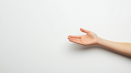 Outstretched female hand reaching, set against a minimalistic white background, symbolizing offering or seeking connection.