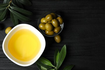 Bowl of fresh olive oil and olives with leaves on white background