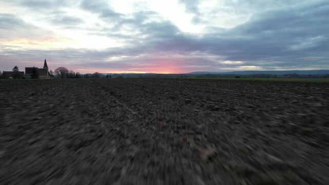 The freshly plowed fields near Beaune stretch toward a colorful sunrise, capturing the essence of Burgundy&rsquo;s agricultural roots and tranquil rural beauty