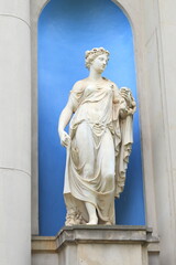 White Statue of Goddess Flora Standing in a Blue Niche in Amsterdam, Netherlands