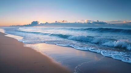 Obraz premium A tranquil beach at dawn, with gentle waves lapping the shore and the first light of day breaking over the horizon