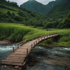 Obraz premium A green mountain with a wooden bridge crossing a nearby river.