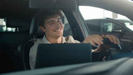 Carefree Caucasian driver man sit inside car turning on radio dancing enjoy sound music song dancing clap with hands on steering wheel drive rent auto road traffic modern computer device automobile