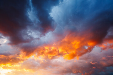 Awesome sunset and ominous clouds before the storm glowing in the sun's rays. Dramatic evening light.