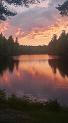 Fototapeta premium Serene Sunset Lake Scene: A tranquil lake reflects the vibrant hues of a breathtaking sunset, surrounded by lush trees and a peaceful ambiance. Capturing the moment where nature's beauty unfolds.