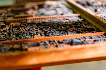 Antique Wooden Letterpress Type Blocks in a Print Shop, Highlighting Craftsmanship and the Art of Traditional Printing Techniques Through a Close-Up View of Historic Printing Instruments
