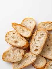 Naklejka premium Culinary Artistry: Pile of Golden Crusted Baguette Slices on White Background. Photorealistic Food Composition for Premium Design Needs.