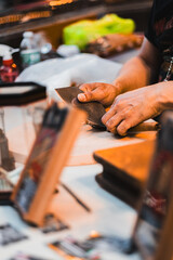 Hands Crafting Cigars in Traditional Artisanal Workshop Setting with Tools and Materials for a Unique Handmade Experience Captured in Vibrant Detail and Warm Ambient Lighting