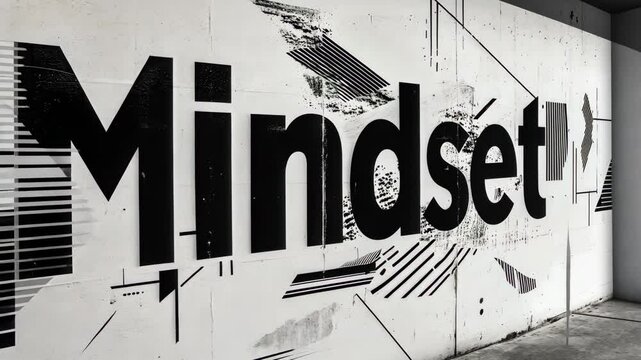 Mindset word displayed on white wall with black spray paint changing position
