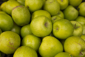 Delicious green apples on a market counter