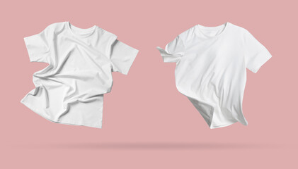 White t-shirts in air on pink background