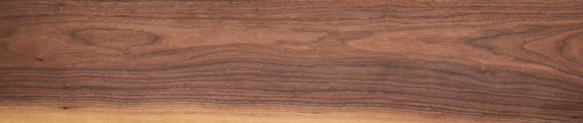 Walnut wood texture background. Walnut plank top. Long plank texture background. Panoramic wood plank texture background. Walnut wood plank natural texture. Panoramic background elements.