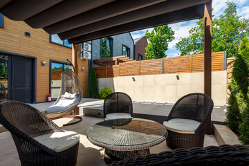 Backyard outdoor bbq zone with pergola, fireplace and hanging chair. Summer party place