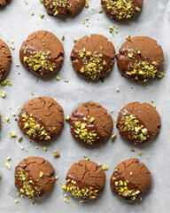 Chocolate Cookies Covered with Chocolate and Sprinkled with Chopped Pistachios – Perfect for Christmas 
