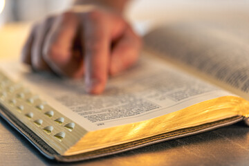 Close-up of the Bible. Holy book Bible. A man reads the Bible.