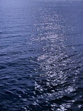 Blue ocean water glittering rippled surface. 