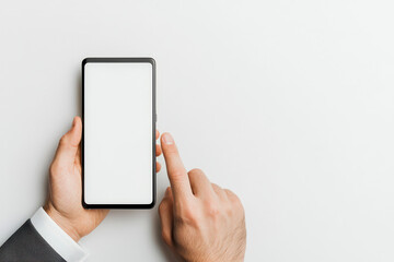 A professional hand navigating a modern smartphone with a blank screen, representing technology and communication.