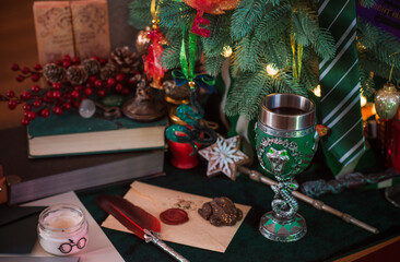 Composition with Christmas sweets, gift and candles on a table in Holidays atmosphere