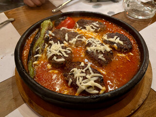 Turkish Kofte or Kofta Meatballs with cheese on a tile plate.