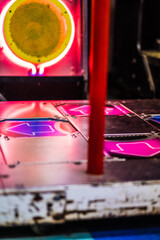 Close-Up of a Vibrant Dance Arcade Game Machine with Illuminated Arrows and Neon Lights in a Nostalgic Arcade Environment Creating a Fun and Retro Ambiance