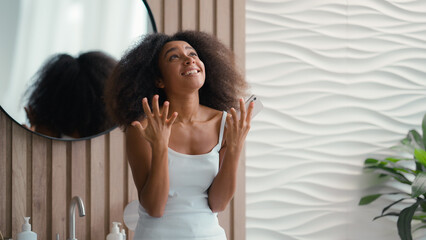 Fototapeta premium Excited female at home achievement with smartphone amazing news result offer happy African American girl woman mobile phone win victory successful yelling rejoice celebrate winning online in bathroom