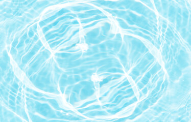 Blue water with ripples on the surface. Defocus blurred transparent blue colored clear calm water surface texture with splashes and bubbles. Water waves with shining pattern texture background.