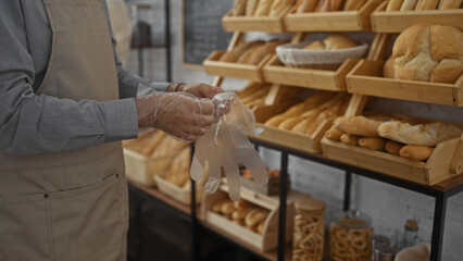 Man wearing gloves in a bakery with various bread displays and a rustic interior