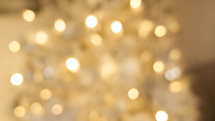 Fototapeta premium Abstract blurred golden and light brown bokeh glowing with festive warmth.