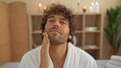 Handsome young man in a spa looking relaxed and content, showcasing his fresh grooming in a serene...