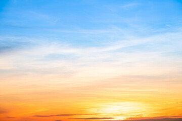 Fototapeta premium Sky,sunset, beautiful , luxury soft gradient orange gold clouds and sunlight on the blue sky perfect for the background, Sunrise on morning or everning in winter warm time ,Twilight summer,silhouette