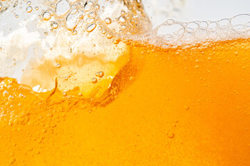 Close up bright orange Oil or beer splash texture and nature waves, Beautiful waves curve and little bubbles smooth for graphic design and background, Oil Bubbles, Soft beer bubbles, Selective focus