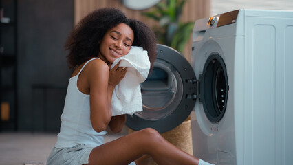 African American woman ethnic girl biracial female housewife householder with laundry open washing...