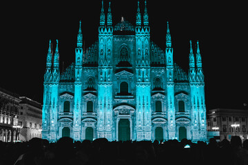 Duomo di Milano Illuminated at Night with Stunning Blue Lighting Against a Starry Sky Showcasing...