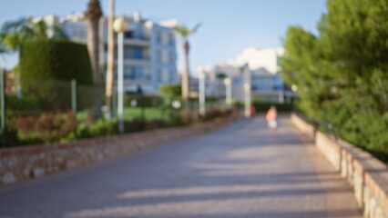 Blurred woman walking on an outdoor path with a defocused background of palm trees and modern...