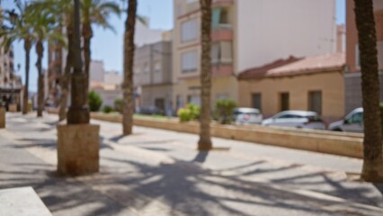 Blurred street with palm trees and buildings in an outdoor urban setting showcasing bokeh effect on a sunny day