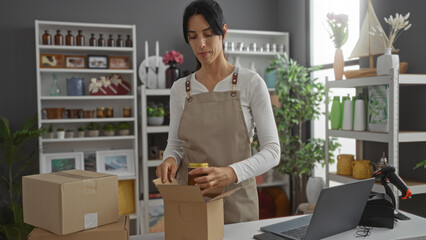 Woman packaging items in a decorated store surrounded by various home decor items and shelves