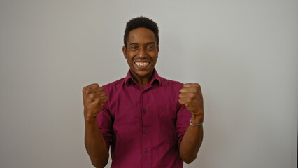 Young man smiling confidently against white background showcasing positive and energetic expression...
