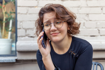 Happy young woman talking on the phone. Emotion concept. Close-up.