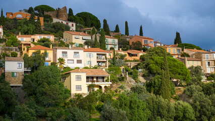 Obraz premium Panoramic view of houses and roofs of medieval village of Bormes-les-Mimosas, in the Var, in Provence, France
