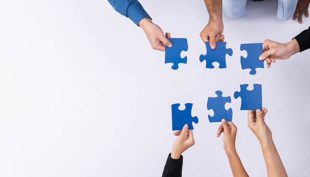 Top view panorama banner of business team joining jigsaw puzzle together over meeting table symbolize business partnership and collective unity teamwork in problem solving solution. Prudent
