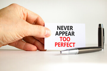 Never appear too perfect symbol. Concept words Never appear too perfect on beautiful white paper. Beautiful white background. Businessman hand. Business never appear too perfect concept. Copy space.