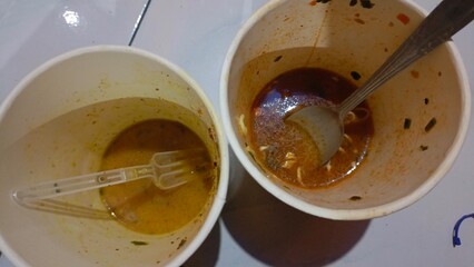 Empty cup off noodle after eating, very oily