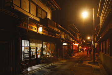 A Charming Nighttime Street Scene Featuring Traditional Japanese Architecture and Vibrant Culture