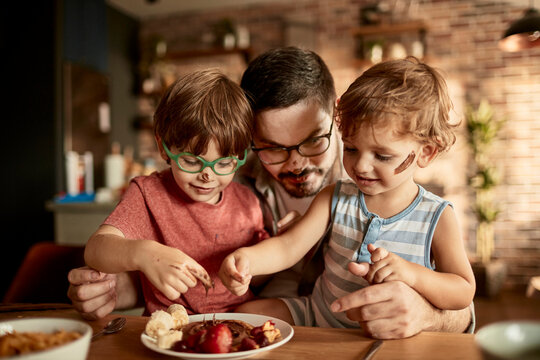 Father and kids enjoying messy pancake breakfast together - Powered by Adobe