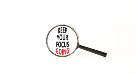Keep your focus going symbol. Concept words Keep your focus going on beautiful magnifying glass. Beautiful white table white background. Business and keep your focus going concept. Copy space.