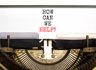 How can we help symbol. Concept words How can we help typed on beautiful old retro typewriter. Beautiful white table white background. Business and how can we help concept. Copy space.