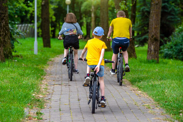 Cyclists ride on the bike path in the city Park
